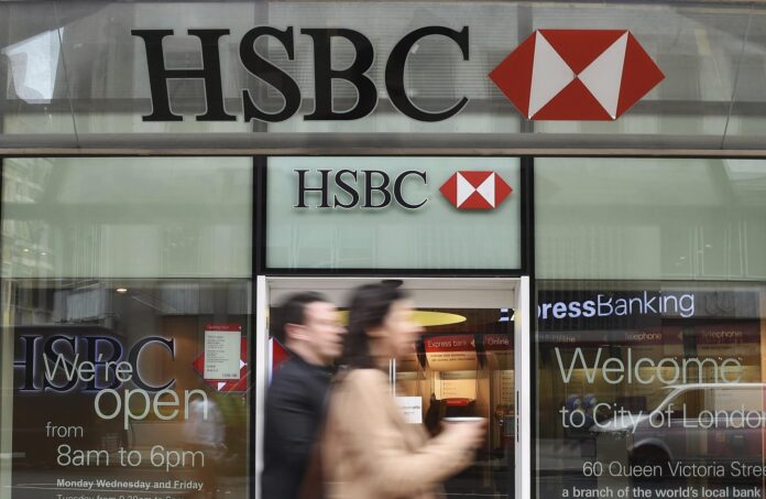 En la imagen de archivo, una pareja camina junto a una filial del banco HSBC en Londres (Reino Unido). EFE/Andy Rain
