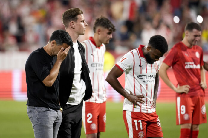 Los jugadores del Girona visiblemente afectados tras el descenso del equipo a Segunda División al término del partido de la jornada 38 de la LaLiga EA Sports entre el Girona Fc y el Elche Fc, este sábado en el estadio municipal de Montilivi.- EFE/ David Borrat
