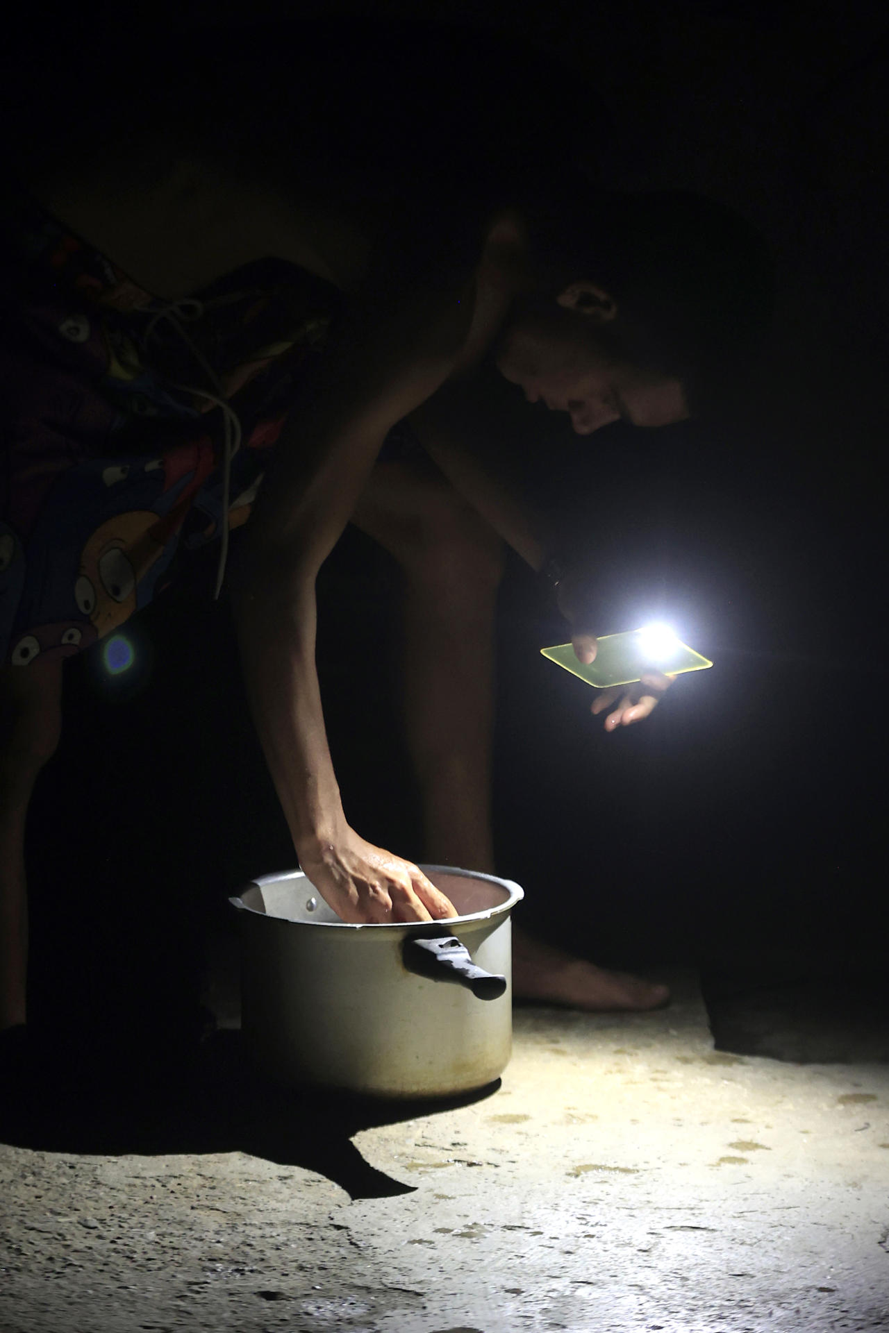 Una persona alumbra con un celular durante un apagón este lunes, en La Habana (Cuba). EFE/ Ernesto Mastrascusa
