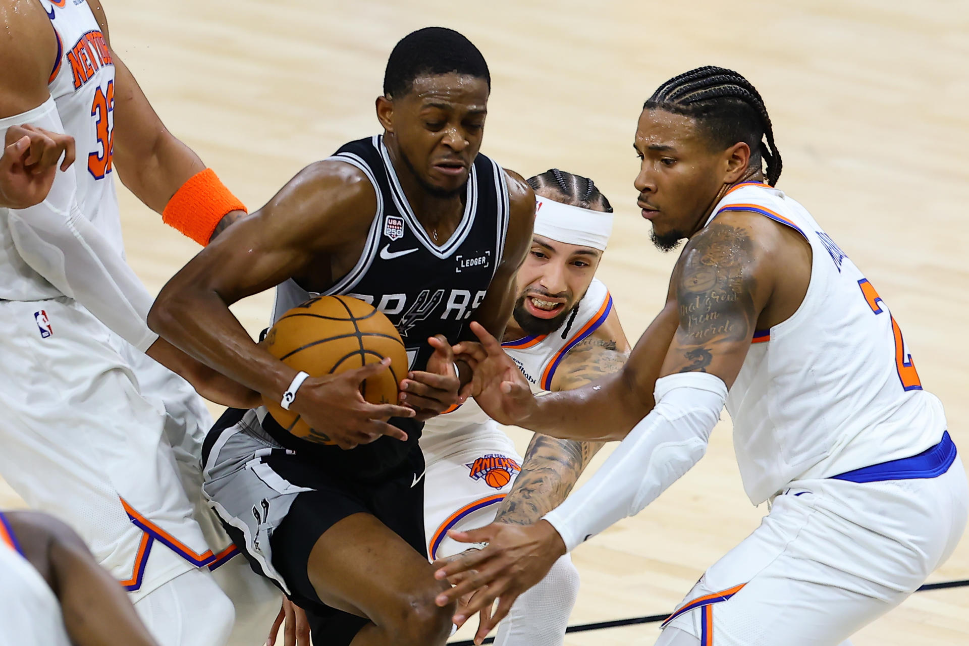 De'Aaron Fox (i), de San Antonio Spurs, disputa el balón con Josh Hart (c) y Miles McBride (d), de los Knicks de Nueva York, este miércoles en el primer partido de las Finales de la NBA. EFE/ Carlos Ramírez
