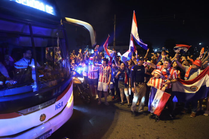 Aficionados de Paraguay despiden a su selección rumbo al Mundial de 2026 este sábado en el aeropuerto Silvio Pettirossi, en Luque. EFE/ Juan Pablo Pino
