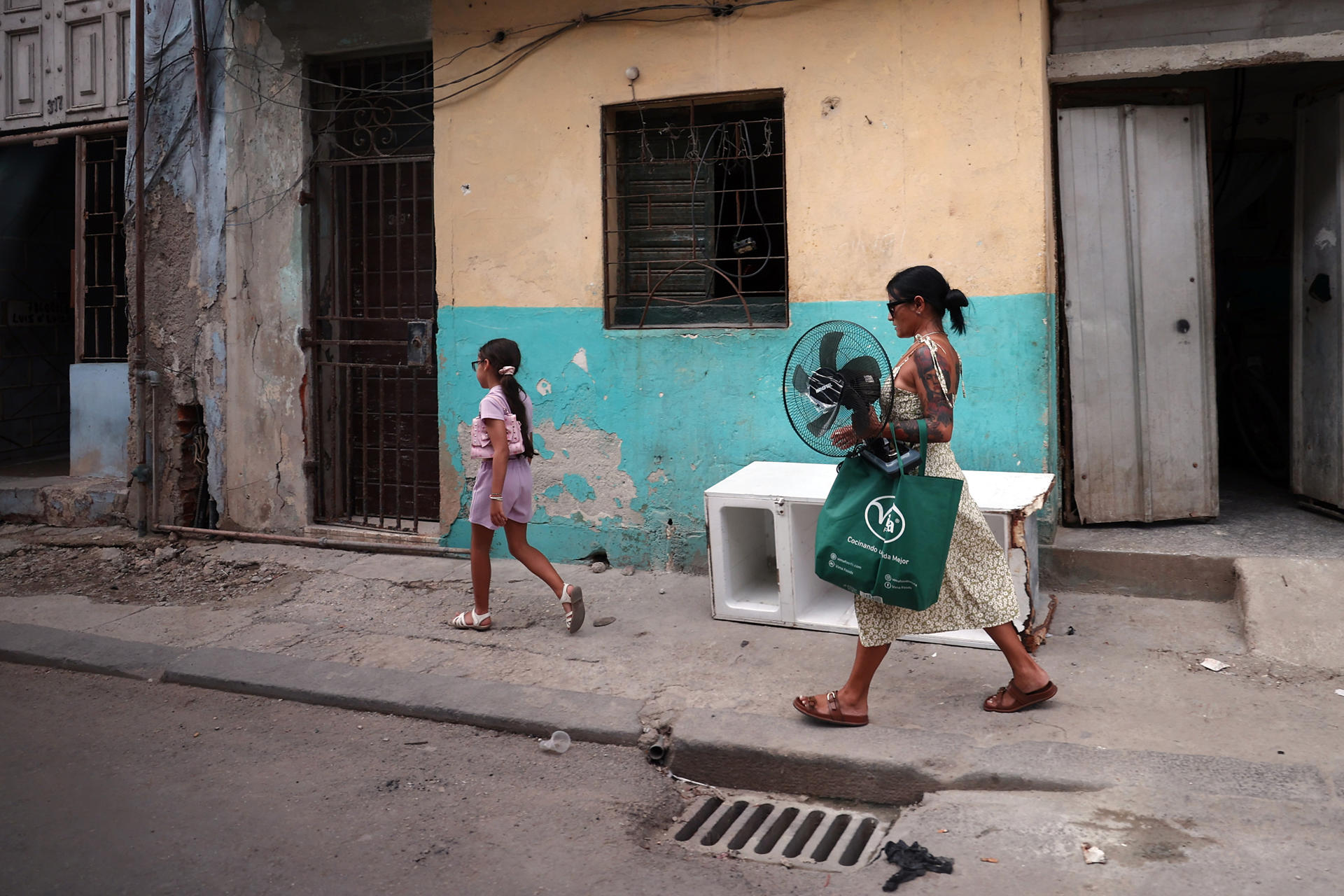 Fotografía del 5 de junio de 2026 que muestra a una niña caminando junto a una mujer en La Habana (Cuba). Los patios de colegio en La Habana están extrañamente silenciosos este junio. Sin transporte ni alimentos para los comedores, el fin del curso escolar se ha adelantado a la fuerza por la intensificación de la crisis derivada del bloqueo petrolero de EE.UU. EFE/ Ernesto Mastrascusa
