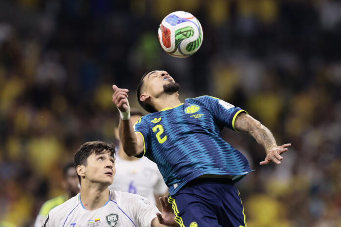 Daniel Muñoz (d) de Colombia cabecea un balón este miércoles, en un partido del grupo K del Mundial de la FIFA 2026 entre Uzbekistán y Colombia, en el estadio Azteca en Ciudad de México (México). EFE/ José Méndez
