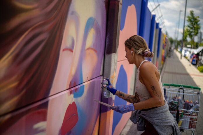 La artista española Amanda Arruti, conocida como Mandioh, realiza un mural de gran escala durante el proyecto 'Mural Ruzyne' en Praga, República Checa, el 18 de junio de 2026 (emitido el 19 de junio de 2026). Este proyecto forma parte del festival Urban Pictus, que se desarrolla del 15 al 30 de junio y presenta 30 obras de destacados artistas checos e internacionales del arte callejero. Cubriendo un muro de hormigón de más de 700 metros de largo, una vez finalizado será el tercer mural más largo de su tipo en Europa. EFE/EPA/MARTIN DIVISEK
