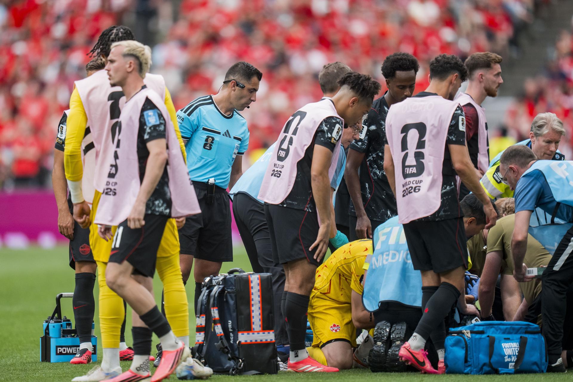 Fotografía del 18 de junio de 2026 en la que se observa al árbitro Cristian Garay (ci) al observar al gravemente lesionado mediocampista canadiense Ismaël Koné en la primera mitad del partido de la fase de grupos de la Copa Mundial de la FIFA 2026 entre Canadá y Catar en Vancouver (Canadá). EFE/BOB FRID
