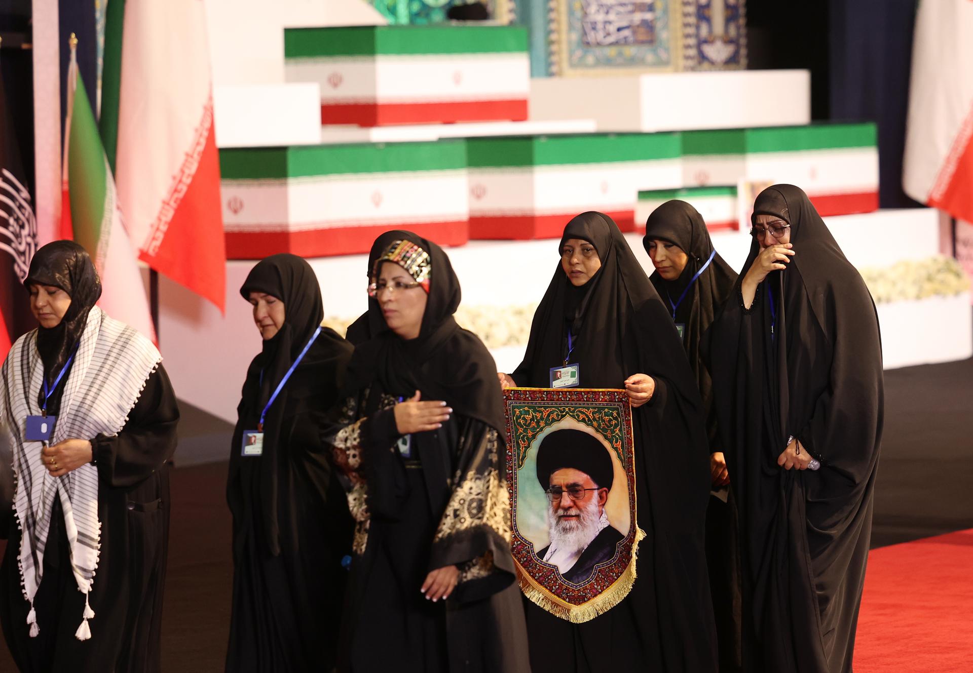 Mujeres sosteniendo un retrato del difunto Líder Supremo de Irán, el ayatolá Alí Jameneí, rinden homenaje junto a su féretro en Teherán, Irán, el 3 de julio de 2026. EFE/EPA/ABEDIN TAHERKENAREH RESTRICCIONES: SIN acceso medios israelíes / estaciones de televisión en idioma persa fuera de Irán / Estrictamente prohibido para BBC Persian / VOA Persian / Manoto TV / Iran International TV. (Según lo ordenado por la Dirección General de Medios Extranjeros de Irán) --