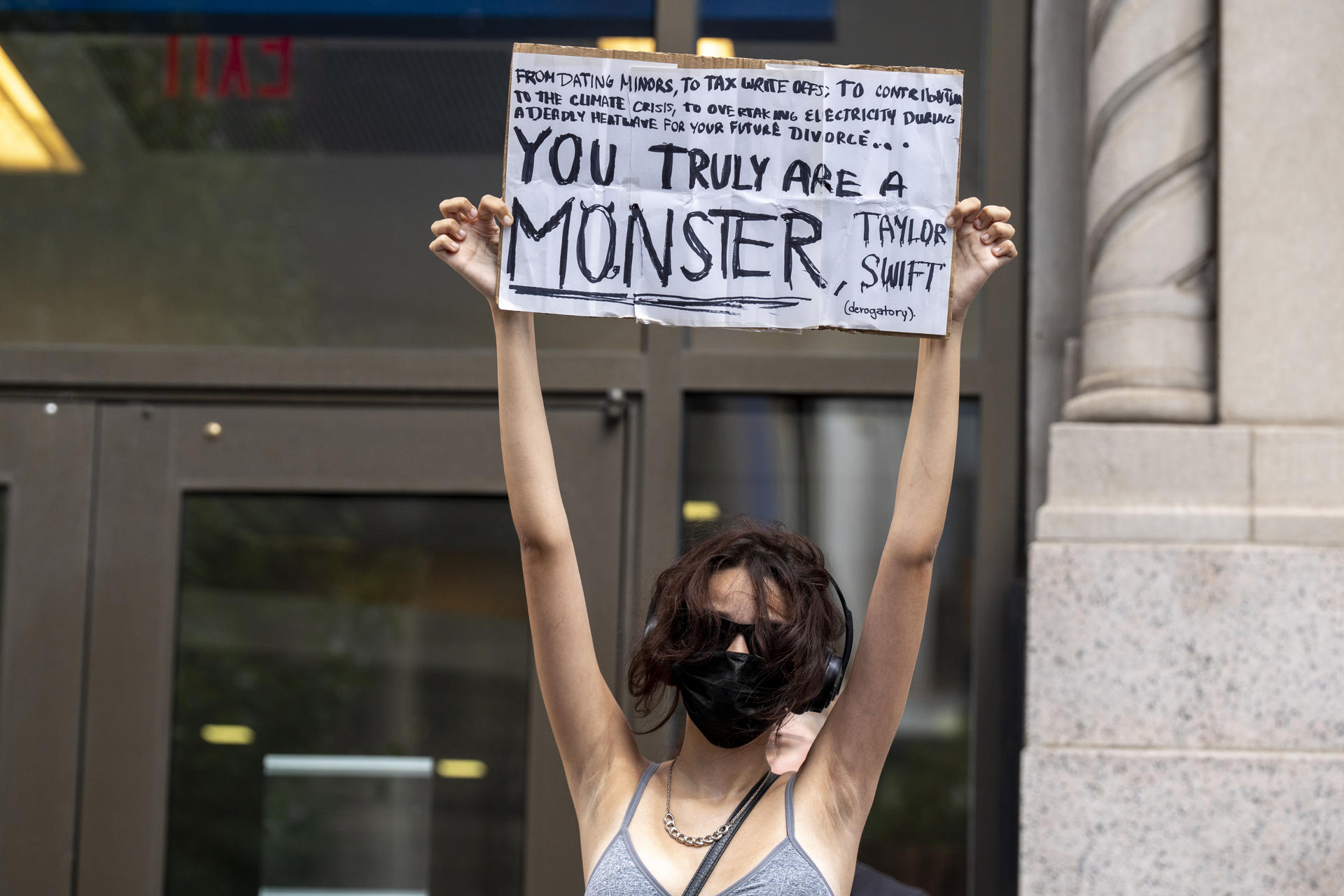 Una mujer sostiene un cartel de protesta durante la boda de la cantante Taylor Swift con el jugador de fútbol americano Travis Kelce en los alrededores del Madison Square Garden en Nueva York (Estados Unidos). EFE/ Ángel Colmenares
