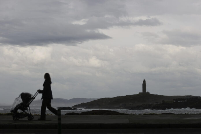 Una mujer empuja un carrito de bebé por el paseo marítimo de A Coruña (noroeste de España), en una imagen de abril pasado. EFE/Cabalar
