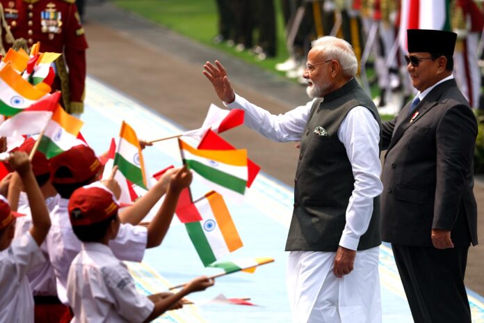 YAKARTA (Indonesia), 07/07/2026.- El primer ministro de la India, Narendra Modi (C), y el presidente de Indonesia, Prabowo Subianto (D), saludan a los niños mientras inspeccionan la fila durante la ceremonia de bienvenida previa a su reunión en el Palacio Merdeka en Yakarta. El primer ministro Modi se encuentra de visita en Indonesia para fortalecer la relación bilateral entre los dos países. EFE/EPA/MAST IRHAM
