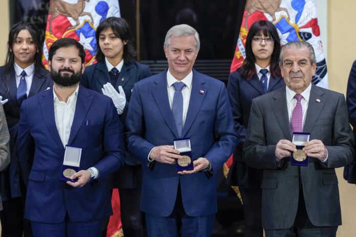El presidente de Chile, José Antonio Kast (c), y los expresidentes Gabriel Boric (i) y Eduardo Frei sostienen medallas durante la conmemoración de los 200 años de la Presidencia de la República de Chile, en el Museo Histórico Nacional, en Santiago (Chile). EFE/ Adriana Thomasa
