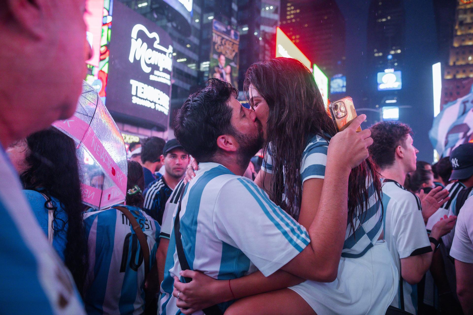Una pareja se besa mientras miles de aficionados argentinos se concentran en Times Square en vísperas de la final del Mundial 2026 entre la selección de su país y la de España, que se disputa este domingo. EFE/OLGA FEDOROVA