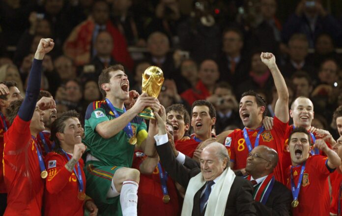 El capitan de la selección española de fútbol, Iker Casillas (de verde), recibe la copa del Mundial de Sudáfrica que la selección española consiguió tras vencer en la final a la selección de Holanda por 1-0. Archivo EFE/Cézaro de Luca

