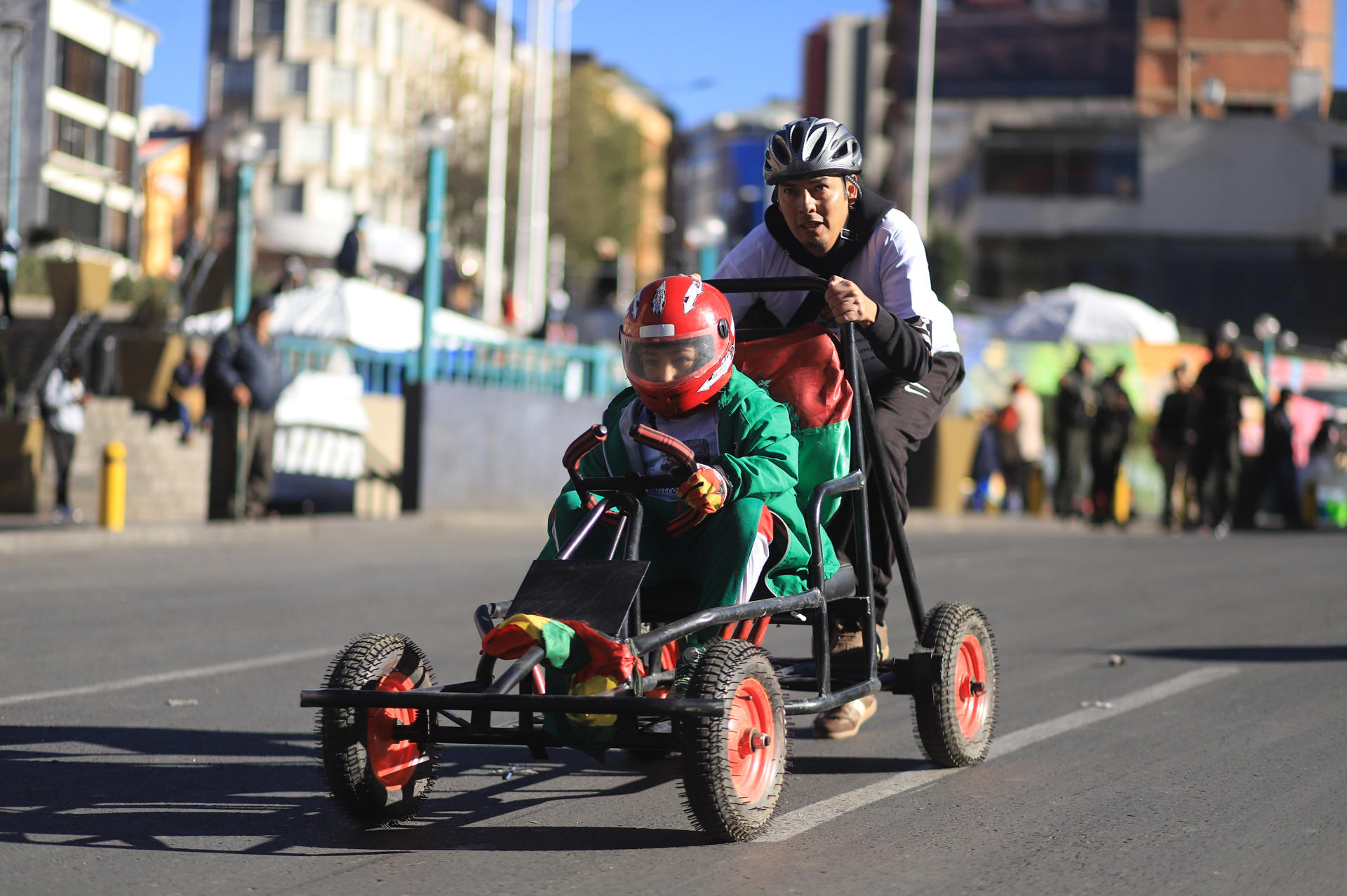 Personas participan en la XXV Carrera de Cochecitos sin Motor una tradición que une a padres e hijos para esta actividad que se realiza este sábado en las empinadas calles de La Paz (Bolivia). EFE/Gabriel Màrquez