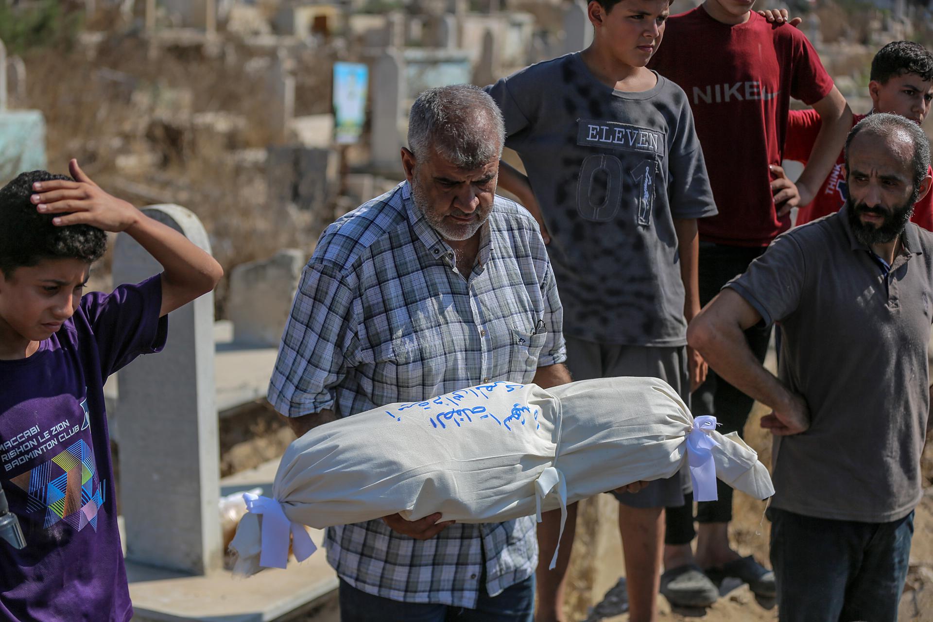 Familiares palestinos de la familia Al-Masri lloran junto a sus cuerpos en la morgue del Hospital Al-Shifa, en la ciudad de Gaza, Franja de Gaza. EFE/ Mohammed Saber