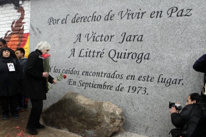 Fotografía de archivo, tomada el 13 de septiembre de 2014, en la que se captó a la viuda del cantautor chileno Víctor Jara, Joan Jara (3-i), durante la inauguración del memorial en homenaje al legendario artista chileno, en las afueras del Cementerio Metropolitano de Santiago de Chile (Chile). EFE/Sebastián Silva
