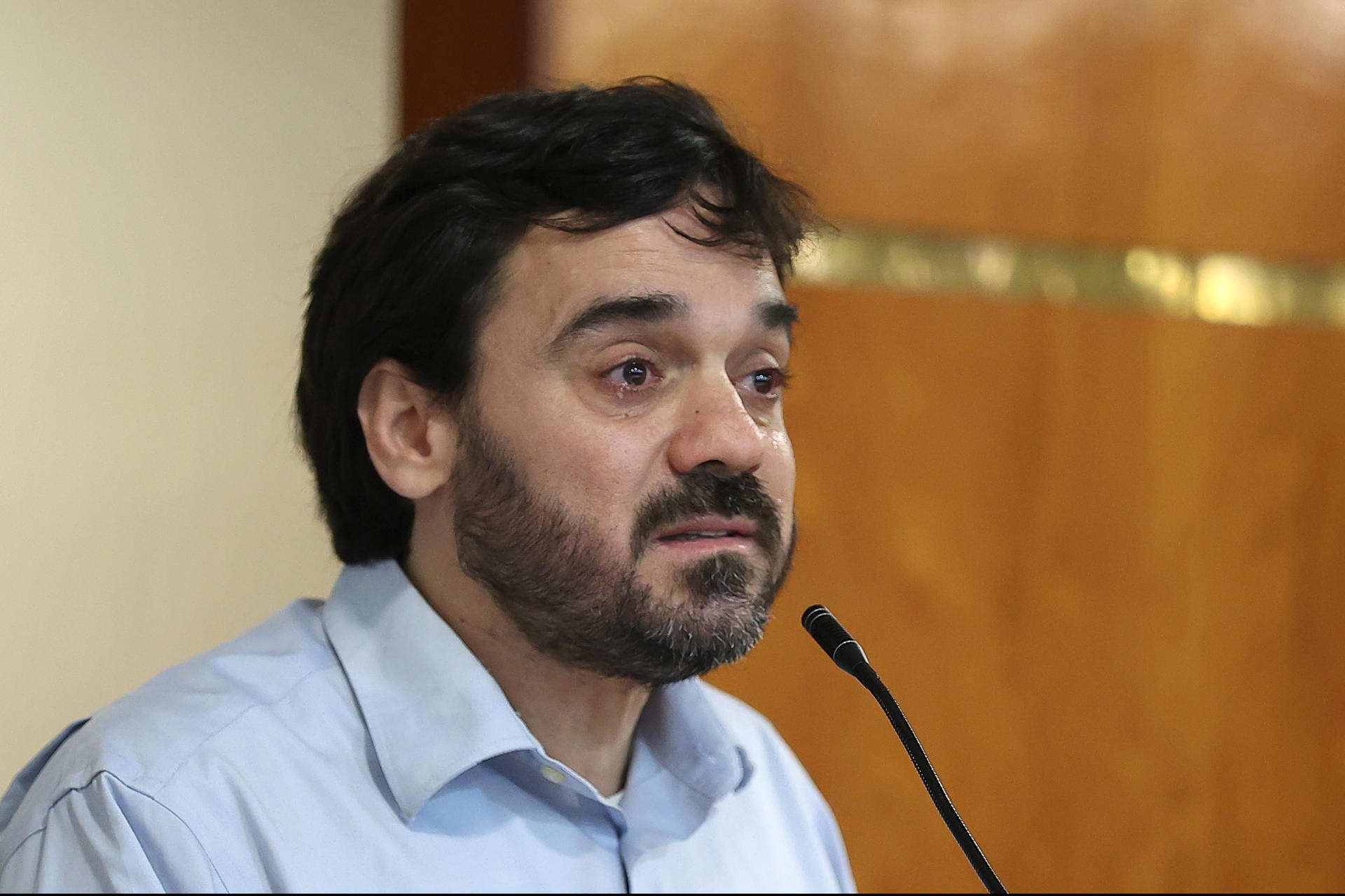 El secretario ejecutivo de la Coordinadora de Derechos Humanos de Paraguay, Dante Leguizamón, llora durante el acto de reconocimiento de responsabilidad internacional y cumplimiento de la sentencia por parte del Estado paraguayo en el caso Santiago Leguizamón Zaván, este lunes en Asunción (Paraguay). EFE/ Juan Pablo Pino
